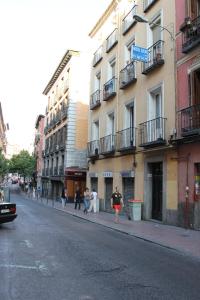 a group of people walking down a city street at Hostal Xucar in Madrid