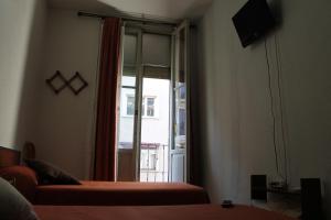 a room with a bed and a sliding glass door at Hostal Xucar in Madrid
