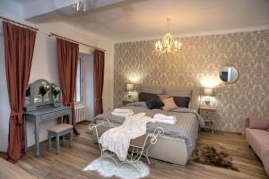 a bedroom with a bed and a desk and a couch at Křišťanka - kouzelné apartmány in Prachatice