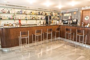 a bar at a restaurant with stools at Hostal Nirvana in Ponferrada