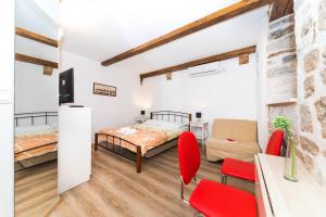 a bedroom with a bed and a desk and chairs at First Vestibul in Split