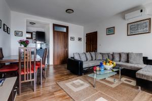 a living room with a couch and a table at Villa Ladera Lapcici in Budva