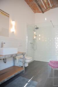 a white bathroom with a sink and a toilet at Freiraum Loft in Markkleeberg