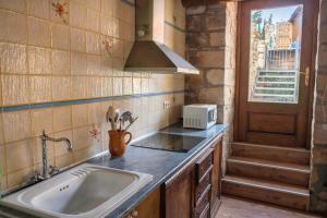 a kitchen with a sink and a microwave at MARILLUNA aixoplucrural in Montblanquet