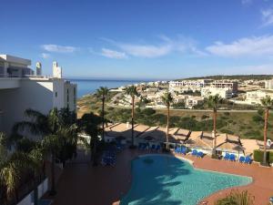 a view of a resort with a swimming pool and the ocean at Sweden Apartment - Top Floor one bedroom with sea views - RS in Lagos +23 photos