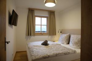 a bedroom with a bed with a teddy bear on it at Kitzbuheler Alpen Residenz Top2 Hollersbach in Hollersbach im Pinzgau