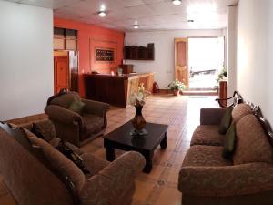 a living room with two couches and a table at Hostal Casa Vieja in Matagalpa