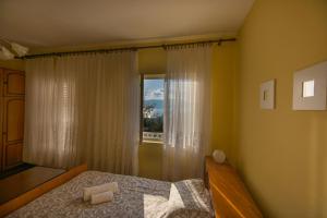 a bedroom with a bed and a window at Holiday Home Nives in Tivat