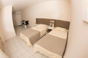Un pat sau paturi într-o cameră la Hotel Central Caruaru