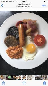 un plato de desayuno con un huevo y judías en bishop gate bnb en Derry