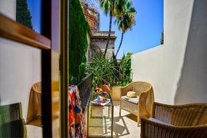 a view through a window of a patio area at Hotel Casa Del Poeta in Seville