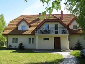 a large house with a balcony on top of it at Willa Nauta in Dębki