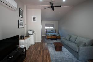 a living room with a couch and a bed at Pound Creek Gallery in Tumbarumba