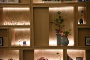 a room with a window with a vase with flowers in it at Compass Hotel Nagoya in Nagoya