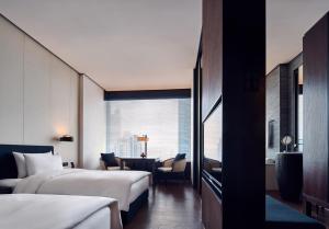 a hotel room with two beds and a window at The Puli Hotel And Spa in Shanghai