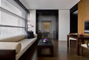 a living room with a couch and a table at The Puli Hotel And Spa in Shanghai