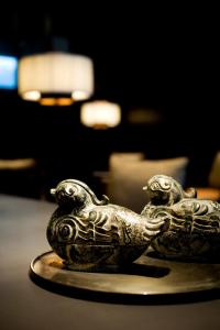 two metal birds sitting on top of a table at The Puli Hotel And Spa in Shanghai