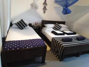 Postel nebo postele na pokoji v ubytování Asiri HomeStay