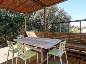 a wooden table and chairs on a wooden deck at Eddies Place by Discover Stradbroke in Point Lookout