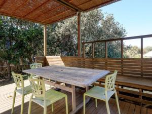 a wooden table and chairs on a wooden deck at Eddies Place in Point Lookout