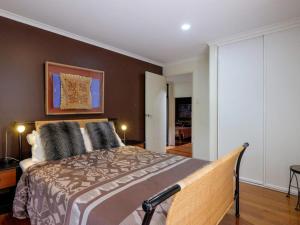 a bedroom with a large bed in a room at Straddie Beach House 2 in Point Lookout