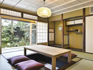 a dining room with a table and a large window at Kyo no Ondokoro FUYACHO-NIJO #4 in Kyoto