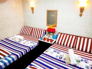 Postelja oz. postelje v sobi nastanitve First Inn Hotel & Guest House Reception at 10TH F, Block E