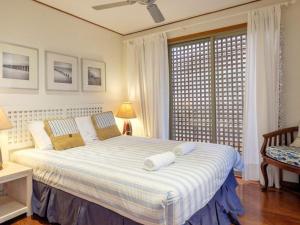 a bedroom with a large bed with two towels on it at Claytons 8 by Discover Stradbroke in Point Lookout