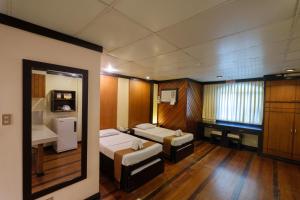 Zimmer mit 2 Betten und einem Waschbecken. in der Unterkunft Lispher Inn in Davao City
