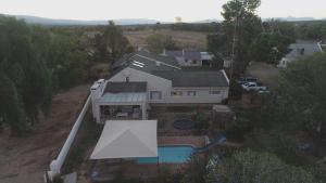 an aerial view of a house with a pool at Karoo Living in Oudtshoorn