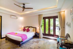 Voodi või voodid majutusasutuse Hoian Central Hotel toas