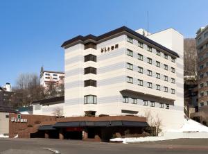 a white building with people on top of it at Yumoto Noboribetsu in Noboribetsu