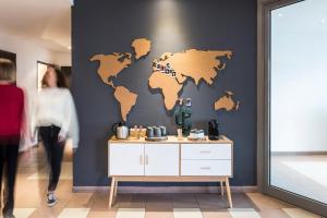 a room with a map of the world on a wall at Aparthotel Adagio Access Strasbourg Illkirch in Illkirch-Graffenstaden
