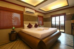 a bedroom with a large bed in a room at Hill Top Luxury Villa - 3 BHK || Infinity Pool in Mapusa