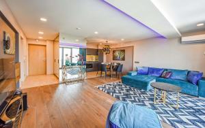 a living room with a blue couch and a table at Palanga Sea View in Palanga