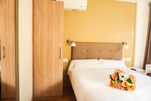 a bedroom with a bed with a bouquet of flowers on it at Hotel Lidar in Bilbao