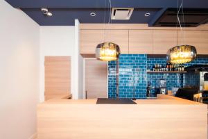 a bar in a restaurant with blue tile at Oakwood Apartments Nishi-Shinjuku Tokyo in Tokyo