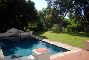 a swimming pool in the middle of a yard at Appleby Guesthouse in Cape Town