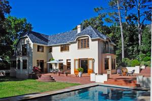 a house with a swimming pool in front of it at Appleby Guesthouse in Cape Town