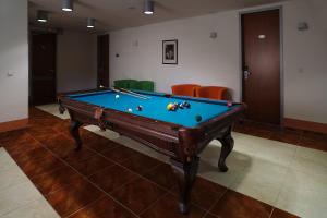 a living room filled with furniture and a pool at Hotel Ankora in Prague