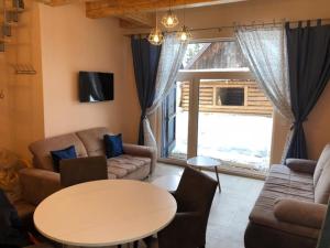 a living room with a couch and a table at Chalupa U dedka in Legnava