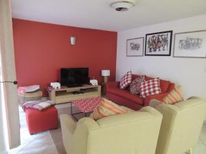 a living room with two couches and a tv at Sand and Sea 25 in Swakopmund