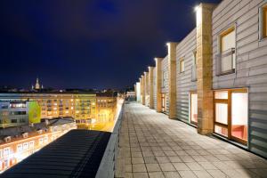 a city street at night with buildings and lights at Pytloun City Boutique Hotel in Liberec