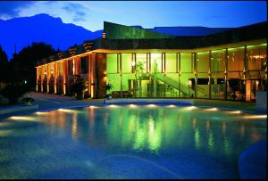 a building with a swimming pool in front of a building at Kurhotel Falter in Bad Reichenhall