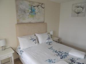 a bedroom with a bed with blue flowers on it at Sand and Sea 25 in Swakopmund
