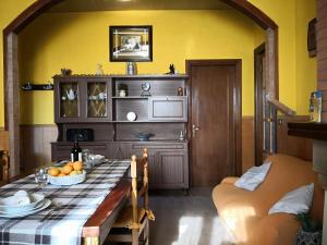 a dining room with a table and a yellow wall at CASA VACANZE SONIA in Amelia