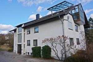 a white house with a balcony on top of it at Appartment Indira in Bad Sobernheim