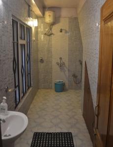 a bathroom with a sink and a toilet at Quinton Enclave in Shillong