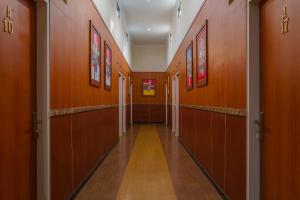 a hallway with wooden stalls in a building at RedDoorz Plus near IPDN in Sumedang