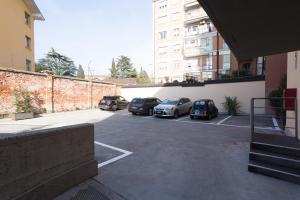 a parking lot with cars parked next to a building at Albergo Residenza Al Teatro in Udine